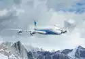 Myloview Fototapeta Biały Samolot Pasażerski Nad Górami